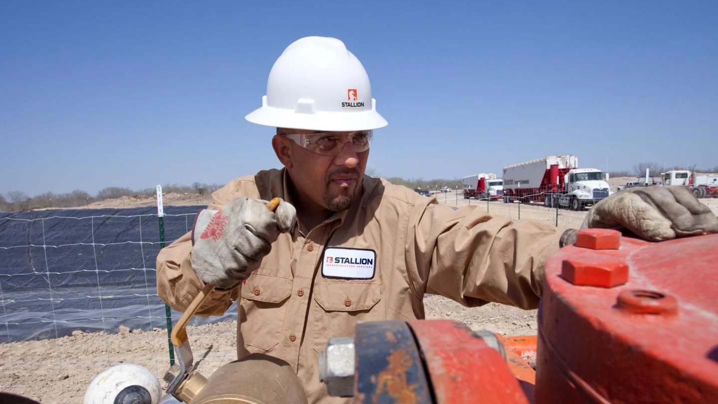 Stallion employee working on equipment
